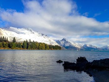 Scenic view of snowcapped mountain against cloudy sky