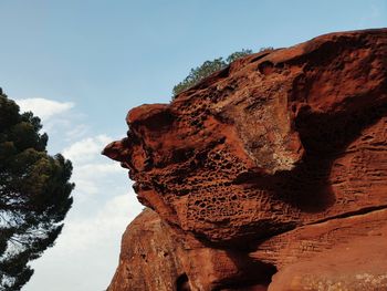 Low angle view of rock formation against sky