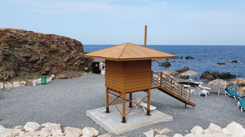 Lifeguard hut on beach against sky