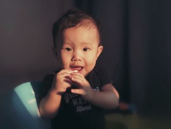 Portrait of cute boy holding camera