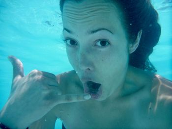 Close-up of woman swimming underwater