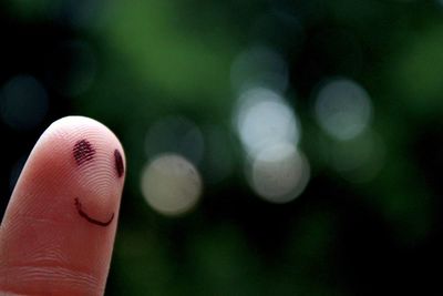 Cropped image of finger with anthropomorphic face