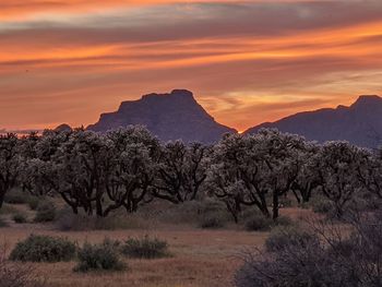 Scenic view of rocky mountains against sky during sunset