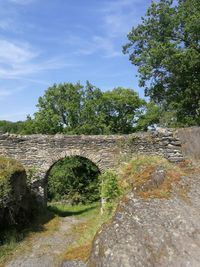 Old ruin amidst trees against sky