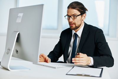 Mid adult man using laptop on table