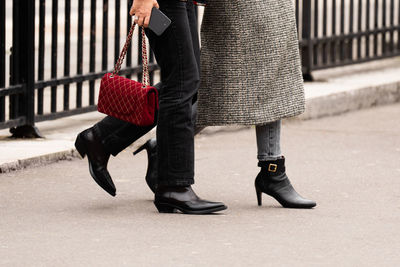 Low section of people walking on street