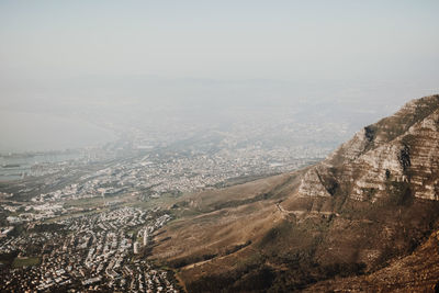 High angle view of city and mountains against sky