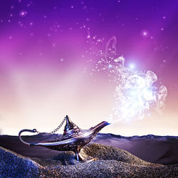 Close-up of magic lamp against purple sky