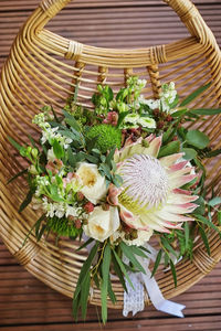 High angle view of flowering plant in basket on table
