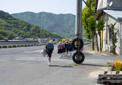 Japanese school children walking along the road