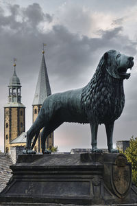 View of statue of building against cloudy sky