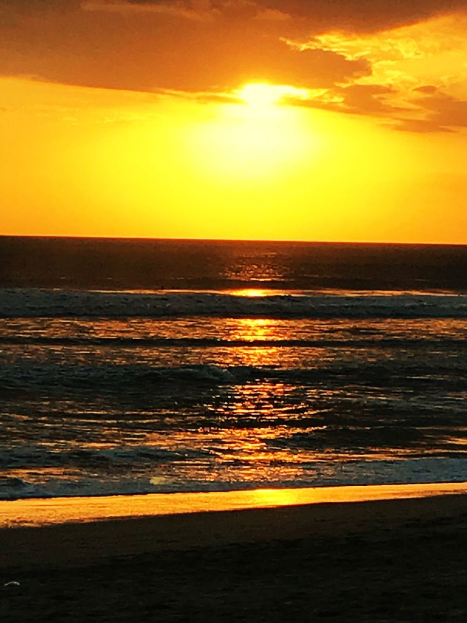 SCENIC VIEW OF SEA AT SUNSET