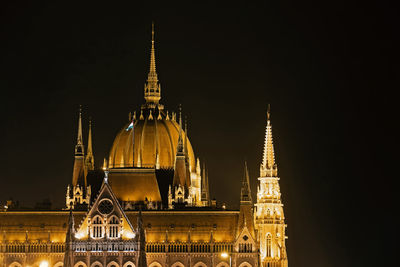 Illuminated building against sky at night