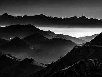 Scenic view of silhouette mountains against sky