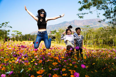 Full length of mother and daughter on flowering plants