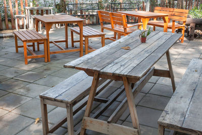 Empty chairs and tables at sidewalk cafe