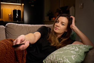 Portrait of young woman sitting at home