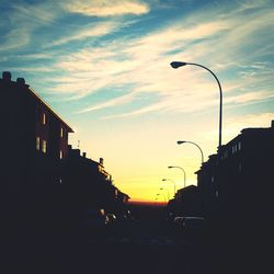 Traffic on city street at sunset