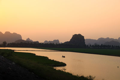 Scenic view of lake against sky during sunset