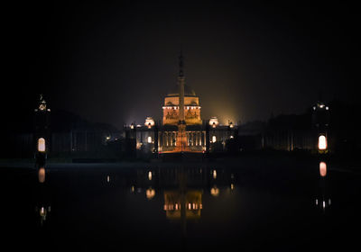 Illuminated temple against sky at night