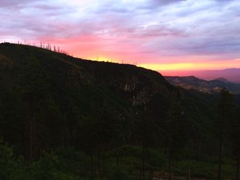 Scenic view of mountains against cloudy sky