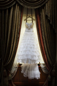 Wedding dress hanging indoors