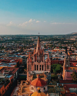 High angle view of illuminated buildings in town against sky