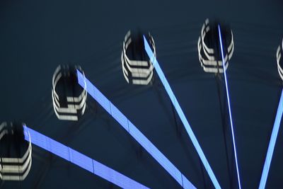 Low angle view of illuminated ferris wheel at night