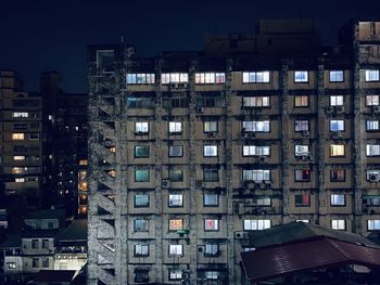 Illuminated buildings against sky at night