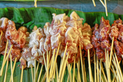 Fresh thai bar-b-q barbecue on banana leaf at street food night market in thailand