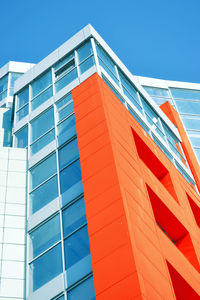 Low angle view of modern building against blue sky