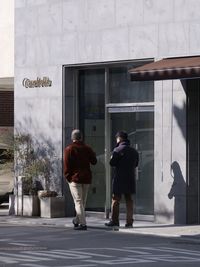 Rear view of people walking in building