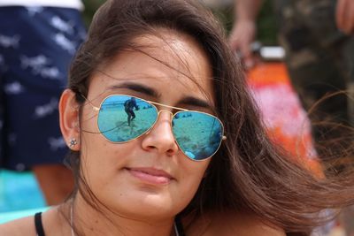 Close-up portrait of young woman in sunglasses