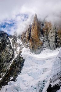 Scenic view of snow covered mountains against sky