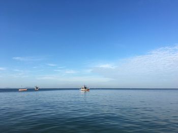 Sailboat in sea against blue sky