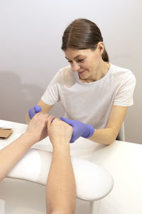 Side view of young woman exercising in bathroom