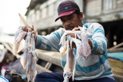 Man holding fish in city