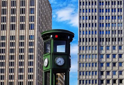 Low angle view of clock tower against buildings in city