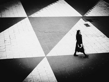 High angle view of woman walking on footpath