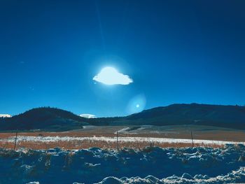 Scenic view of mountains against clear blue sky