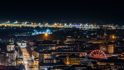 High angle view of city lit up at night