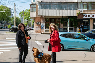 Side view of man with dog on street