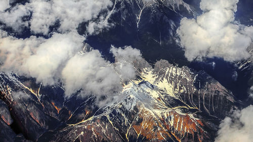 Scenic view of snow covered mountains against sky