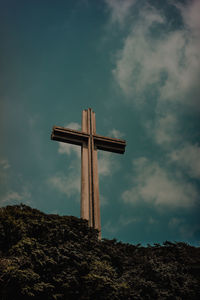 Low angle view of cross against sky