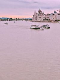 View of boat in city at sunset