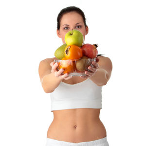Midsection of woman holding apple against white background