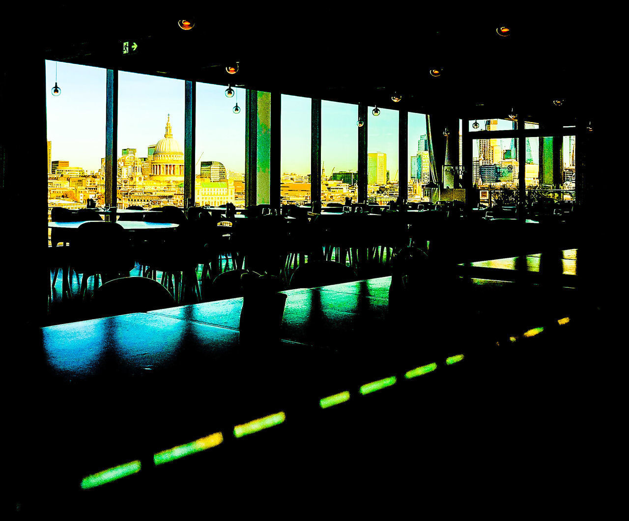 CHAIRS AND TABLE BY WINDOW WITH REFLECTION