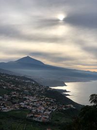 High angle view of town by sea against sky