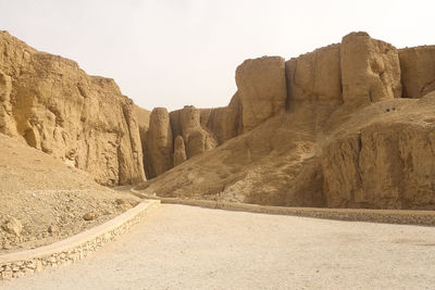 Road amidst rocks against clear sky