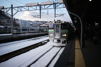 Train at railroad station platform against sky